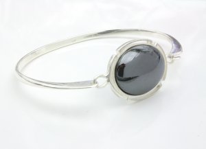 Silver bangle with 25x18mm oval haematite cabochon