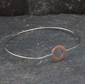 Silver bangle with copper circle