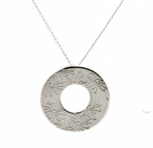 Silver round washer type pendant with stamped flower design