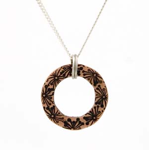 Small circle copper pendant stamped with flowers