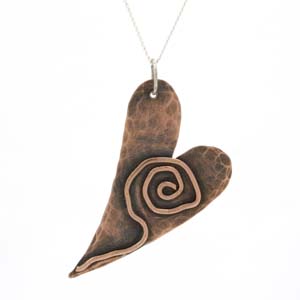 Heart shaped hammered  copper pendant with copper detail