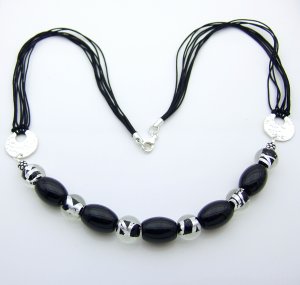 Black onyx and silver foil beads with hammered silver discs. 