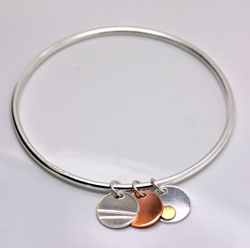 Silver bangle with discs