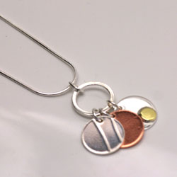 pendant with silver, copper and brass discs